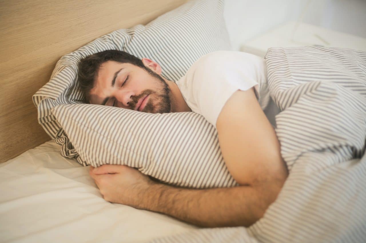 Man sleeping comfortably in bed.