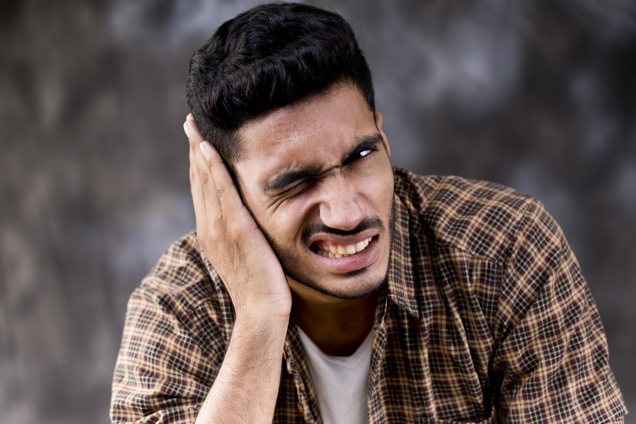 Man with a ringing sound in his ear, in pain.